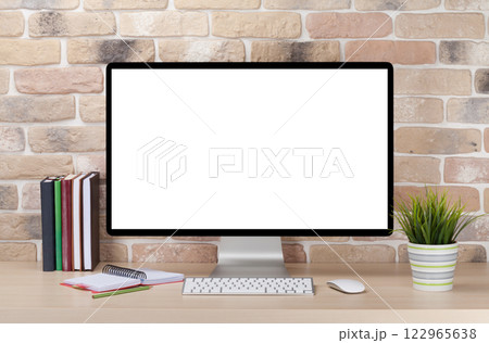 A cozy workplace setup featuring a PC with a blank screen monitor on a desk A cozy workplace setup featuring a PC with a blank screen monitor on a desk 122965638