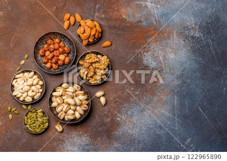 A vibrant assortment of various nuts, including almonds, walnuts, hazelnuts, cashews, and pistachios 122965890