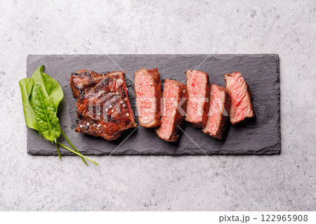 A perfectly cooked sliced striploin steak with a juicy, tender texture A perfectly cooked sliced striploin steak with a juicy, tender texture 122965908