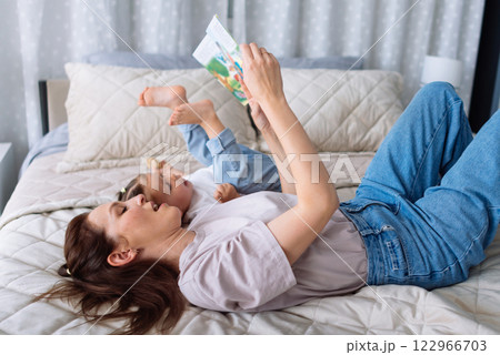 Mother reads a story daughter listens 122966703