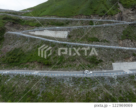 Aerial view of winding road high altitude mountain landscape Aerial view of winding road high altitude mountain landscape 122969069