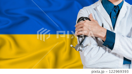 Doctor with stethoscope on Ukraine flag. Doctor holding stethoscope on Ukraine flag Doctor with stethoscope on Ukraine flag. Doctor holding stethoscope on Ukraine flag 122969393