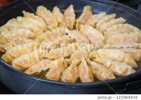Fried dumplings on frying pan. Traditional food Fried dumplings on frying pan. Traditional food 122969438