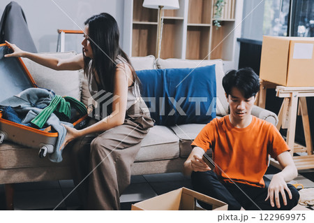 Young frustrated millennial couple sitting on couch at home, using computer and credit card. Buyers try to pay online have shortage of money on bank account. Extra expenses and big spender concept Young frustrated millennial couple sitting on couch at home, using computer and credit card. Buyers try to pay online have shortage of money on bank account. Extra expenses and big spender concept 122969975