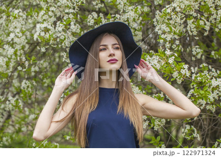 Fashionable spring lady. Beautiful woman outdoors portrait 122971324