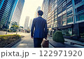 昼のビルの間を歩くサラリーマンの後ろ姿 122971920