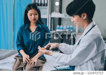 doctor consulting senior old patient filling form at consultation. Professional physician wearing white coat talking to mature woman signing medical paper at appointment visit in clinic. 122972717