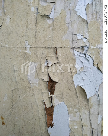 Peeling paint on the wall. Old concrete wall with cracked flaking paint. Weathered rough painted surface with patterns of cracks and peeling. Grunge texture for background and design. High resolution Peeling paint on the wall. Old concrete wall with cracked flaking paint. Weathered rough painted surface with patterns of cracks and peeling. Grunge texture for background and design. High resolution 122973442