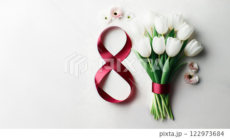 A bouquet of white tulips lies next to the number eight of red color from a satin ribbon on a pink background, 122973684