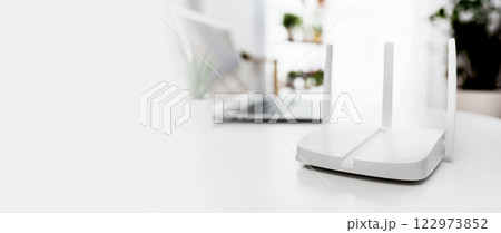 Modern wi-fi router on light table in room 122973852