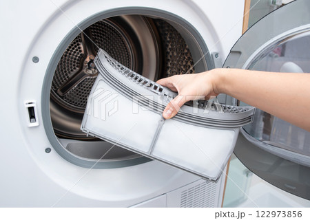 Cleaning dryer lint filter. Laundry dryer 122973856