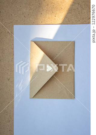 A delicate envelope with a heart design partially opened on a light surface during daylight A delicate envelope with a heart design partially opened on a light surface during daylight 122976670