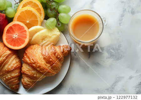 Delicious breakfast with croissants, fresh fruits, and tea 122977132