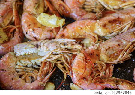 Cooking langoustine on frying pan with butter, lemon and garlic. Fried shrimps. 122977848