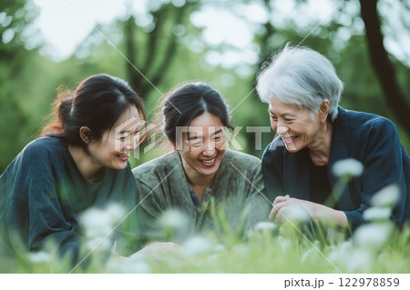 An elderly mother with her daughters laughing 122978859