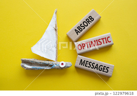 Absorb optimistic Messages symbol. Concept words Absorb optimistic Messages on wooden blocks. Beautiful yellow background with boat. Business and Absorb optimistic Messages concept. Copy space. 122979618