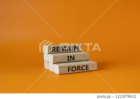 Remain in Force symbol. Concept words Remain in Force on wooden blocks. Beautiful orange background. Business and Remain in Force concept. Copy space 122979622