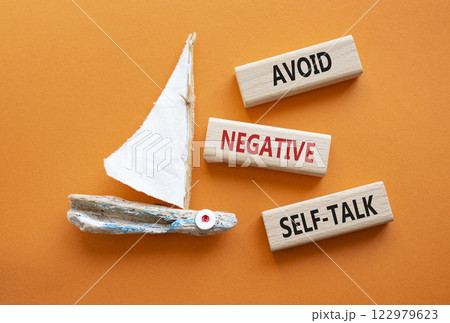 Avoid negative self-talk symbol. Concept words Avoid negative self-talk on wooden blocks. Beautiful orange background with boat. Business and Avoid negative self-talk concept. Copy space. 122979623