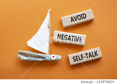 Avoid negative self-talk symbol. Concept words Avoid negative self-talk on wooden blocks. Beautiful orange background with boat. Business and Avoid negative self-talk concept. Copy space. 122979624
