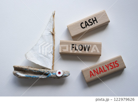 Cash Flow Analysis symbol. Concept words Cash Flow Analysis on wooden blocks. Beautiful white background with boat. Business and Cash Flow Analysis concept. Copy space. 122979626