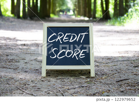 Credit Score symbol. Blackboard with words Credit Score. Beautiful forest background. Business and Credit Score concept. Copy space. 122979652