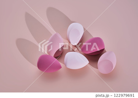A set of makeup sponges on a pink background. 122979691