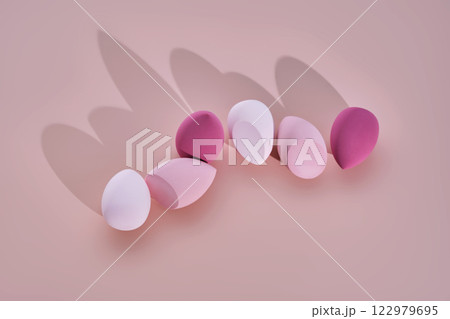A set of makeup sponges on a pink background. A set of makeup sponges on a pink background. 122979695