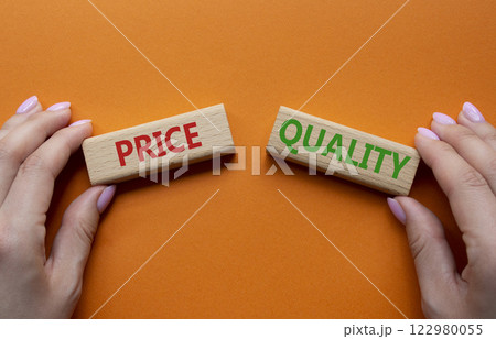 Price and Quality symbol. Concept word Price and Quality on wooden blocks. Businessman hand. Beautiful orange background. Business and Price and Quality concept. Copy space 122980055