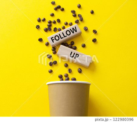 Follow up symbol. Concept word Follow up on wooden blocks. Beautiful yellow background with coffee cup. Business and Follow up concept. Copy space Follow up symbol. Concept word Follow up on wooden blocks. Beautiful yellow background with coffee cup. Business and Follow up concept. Copy space 122980396