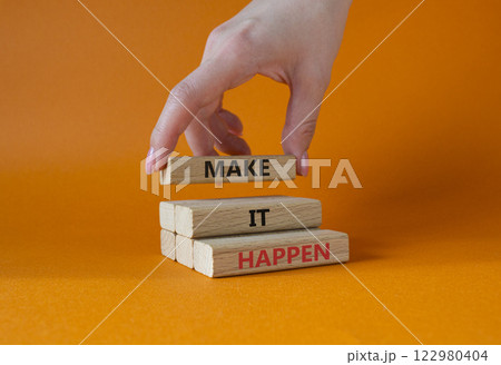 Make it Happen symbol. Concept words Make it Happen on wooden blocks. Beautiful orange background. Businessman hand. Business and Make it Happen concept. Copy space. 122980404