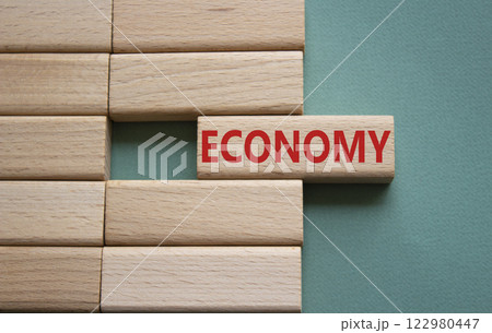 Economy symbol. Concept word Economy on wooden blocks. Beautiful grey green background. Business and Economy concept. Copy space. 122980447