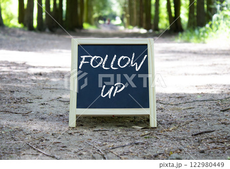 Follow up symbol. Blackboard with words Follow up. Beautiful forest background. Business and Follow up concept. Copy space. Follow up symbol. Blackboard with words Follow up. Beautiful forest background. Business and Follow up concept. Copy space. 122980449