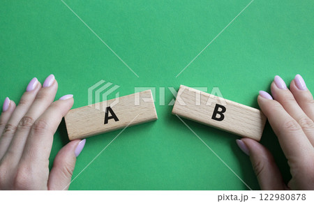Plan A and Plan B symbol. Concept word Plan A and Plan B on wooden blocks. Businessman hand. Beautiful green background. Plan A and Plan B concept. Copy space Plan A and Plan B symbol. Concept word Plan A and Plan B on wooden blocks. Businessman hand. Beautiful green background. Plan A and Plan B concept. Copy space 122980878