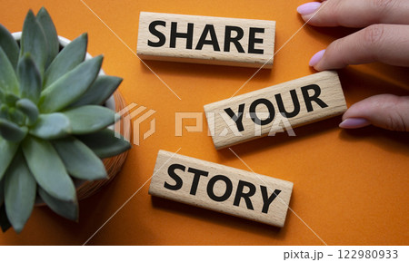 Share your story symbol. Wooden blocks with words Share your story. Beautiful orange background with succulent plant. Businessman hand. Business and Share your story concept. Copy space. 122980933
