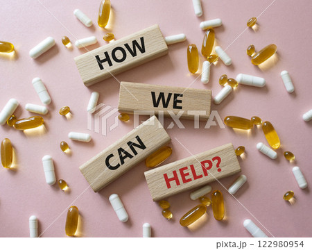 How we can help symbol. Concept word How we can help on wooden blocks. Beautiful pink background with pills. Medicine and How we can help concept. Copy space 122980954