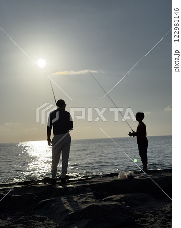 silhouette of a fisherman at sea sunset calm. High quality photo 122981146