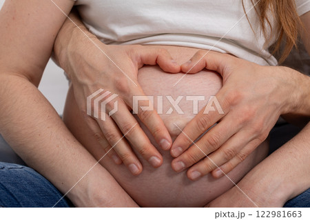 A Beautiful Intimate Moment Shared by Expecting Parents with Their Joyful Baby Bump A Beautiful Intimate Moment Shared by Expecting Parents with Their Joyful Baby Bump 122981663