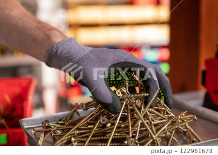 Professional Hand Stocking of Various Hardware Items in the Workshop Environment 122981678