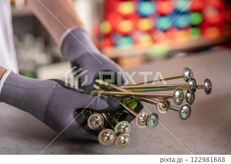 Closeup of hands holding colorful decorative skewers for serving appetizers and dining 122981688