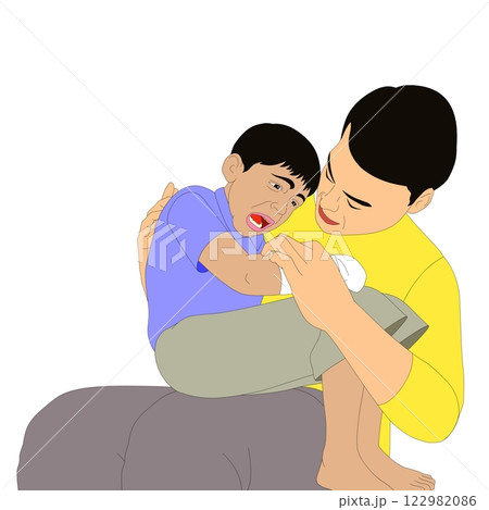 A person in a yellow shirt comforts a child who appears hurt or upset.  122982086