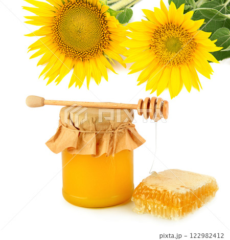 Honey pot, honeycomb, sunflower flowers and wooden drizzler isolated on white. Collage. Honey pot, honeycomb, sunflower flowers and wooden drizzler isolated on white. Collage. 122982412