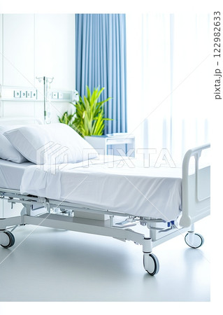 Clean and modern hospital bed with white sheets in a well-lit room featuring medical equipment and green plants 122982633
