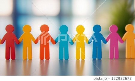 Colorful paper cut-out figures holding hands, symbolizing unity, diversity, and teamwork 122982678