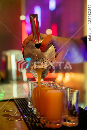 Craft Cocktail Preparation in a Contemporary Bar Setting That Engages Customers and Guests Craft Cocktail Preparation in a Contemporary Bar Setting That Engages Customers and Guests 122982849