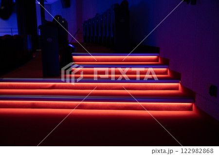 An Illuminated Modern Staircase Featuring Striking Red and Blue Lights for a Unique Ambiance 122982868