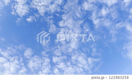 Camera move behind white fluffy clouds on blue sky at summer sunny day. Beautiful nature background. Close up Slow motion Camera move behind white fluffy clouds on blue sky at summer sunny day. Beautiful nature background. Close up Slow motion 122983258