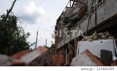 View to destroyed residential buildings at Kharkivska oblast. Ruined houses after bomb attacks on ukrainian territory from russia army. Consequences of russian invasion of Ukraine. Slow motion View to destroyed residential buildings at Kharkivska oblast. Ruined houses after bomb attacks on ukrainian territory from russia army. Consequences of russian invasion of Ukraine. Slow motion 122983264