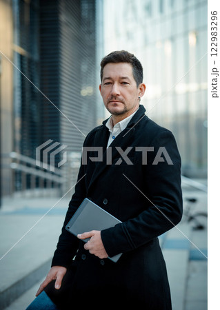 Businessman stand in city center. Dowmntown 122983296