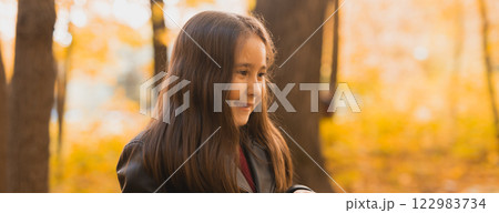 Banner autumn portrait of cute little asian girl. Children, fall and season concept. Copy space Banner autumn portrait of cute little asian girl. Children, fall and season concept. Copy space 122983734