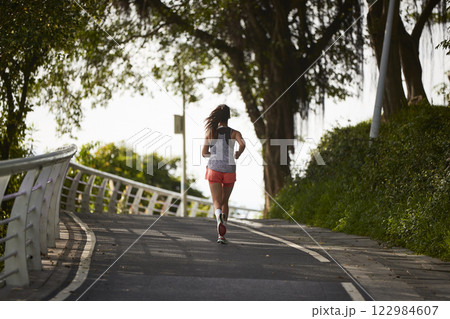 young asian woman jogging running in park 122984607